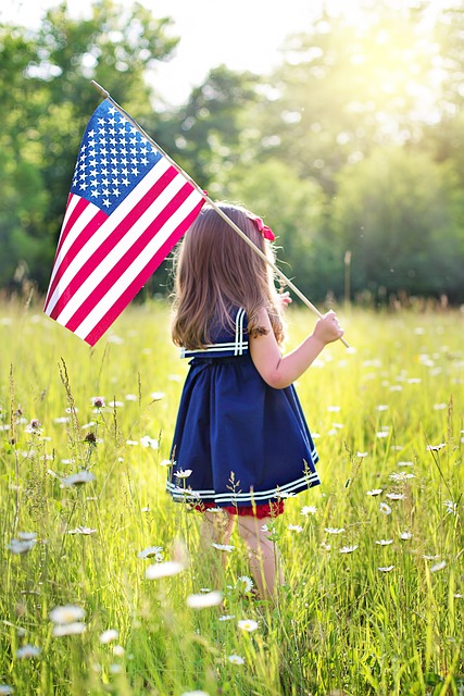 little girl holding a U.S.A. flag